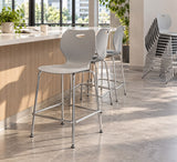 Newstar stackable bar chairs at a café counter with a stack in the background