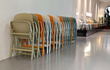 Nova Fold folding chairs folded and stored against a wall